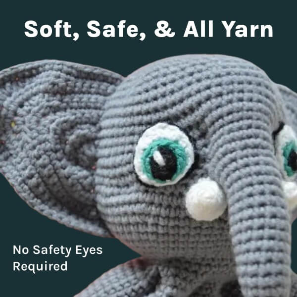 Close-up of Ellie the elephant lovey showing soft yarn eyes and gentle details made entirely from yarn, no safety eyes needed.